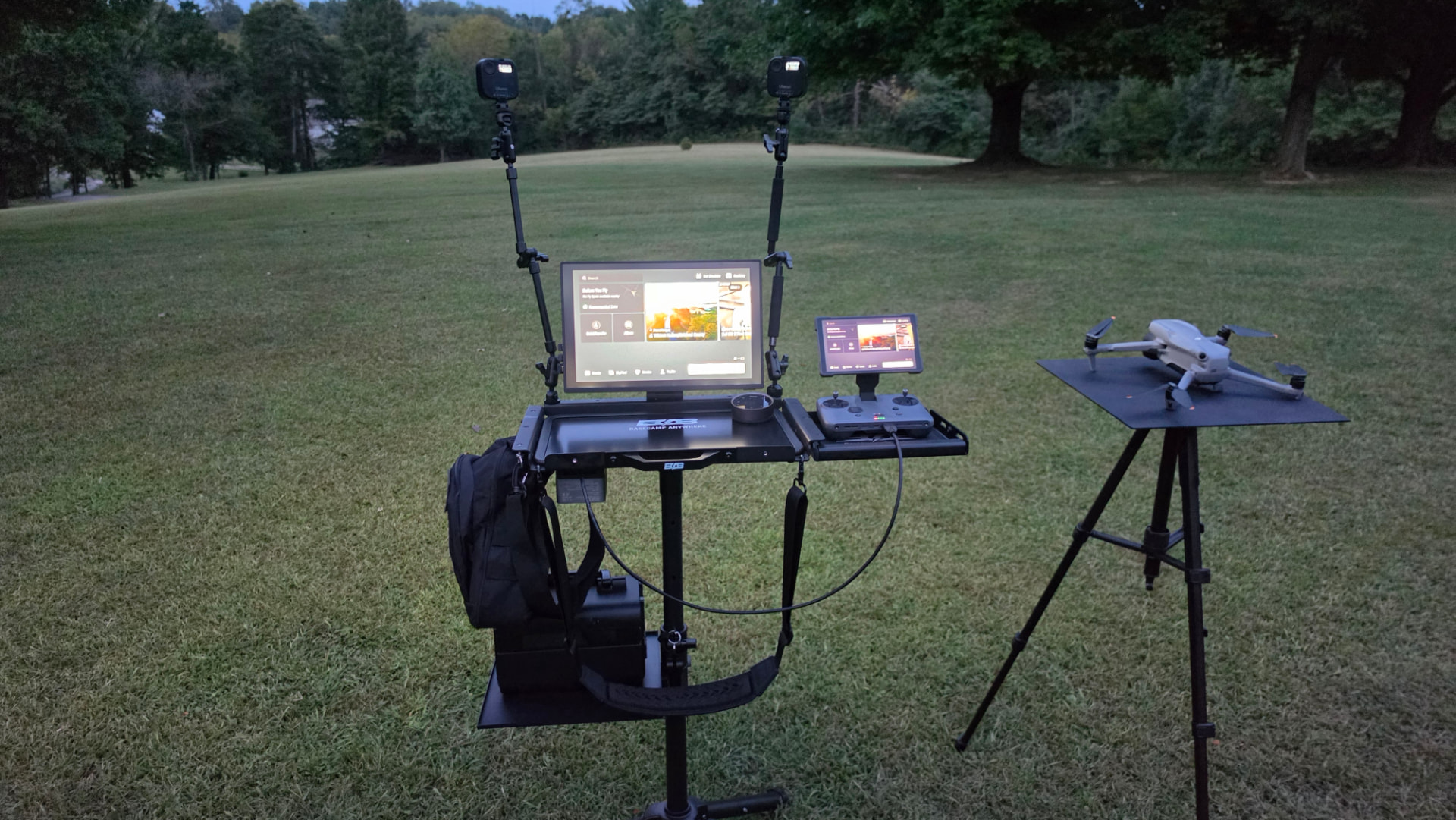 A configured BOB Basecamp platform in an open field at dusk with monitor, controller and drone